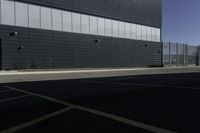 a large black building is sitting near another building that is not yet built by a project