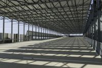 the industrial building has floor to ceiling steel framing, and an aisle for luggage and luggage