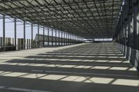 the industrial building has floor to ceiling steel framing, and an aisle for luggage and luggage