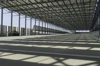 the industrial building has floor to ceiling steel framing, and an aisle for luggage and luggage