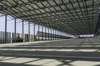 the industrial building has floor to ceiling steel framing, and an aisle for luggage and luggage