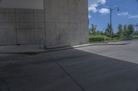 a man on a skateboard doing tricks on cement ground near a parking garage door