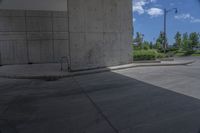 a man on a skateboard doing tricks on cement ground near a parking garage door