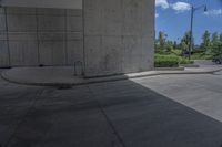 a man on a skateboard doing tricks on cement ground near a parking garage door