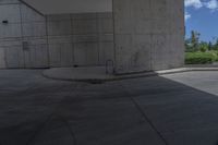 a man on a skateboard doing tricks on cement ground near a parking garage door