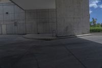 a man on a skateboard doing tricks on cement ground near a parking garage door