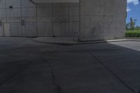 a man on a skateboard doing tricks on cement ground near a parking garage door