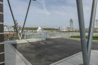 a parking lot in the foreground is made up of two metal poles with a square structure underneath it