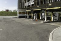 a parking garage with no one in it at the entrance to the building and on the sidewalk