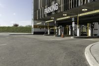 a parking garage with no one in it at the entrance to the building and on the sidewalk