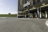 a parking garage with no one in it at the entrance to the building and on the sidewalk