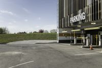 a parking garage with no one in it at the entrance to the building and on the sidewalk