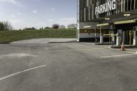 a parking garage with no one in it at the entrance to the building and on the sidewalk