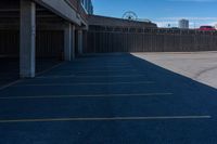 a view of a car parking lot and roller coaster in the background in an urban setting