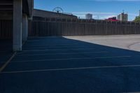 a view of a car parking lot and roller coaster in the background in an urban setting