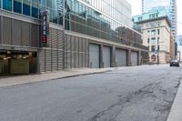 the empty city street has parked cars and parking spaces on each side of it, with a sign that says, don't leave out