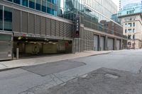 the empty city street has parked cars and parking spaces on each side of it, with a sign that says, don't leave out