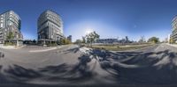 an empty street with cars and buildings in the background, shown from a fish eye view