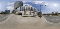 an image of a 360 degrees view of buildings from across the street as seen in a fish eye lens