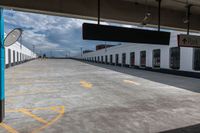 the empty parking lot with a white building on top of it and a yellow doted logo