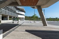 a building that is built into the ground next to a street curb with pillars and columns