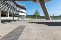 a building that is built into the ground next to a street curb with pillars and columns