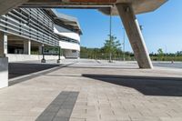 a building that is built into the ground next to a street curb with pillars and columns