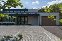 a building with a white sign on the side of it with brown wood doors in a public area