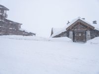 a wooden cabin and snow covered road in a neighborhood on a cold winter day in winter