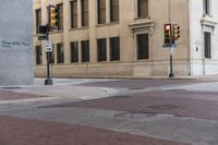 a corner with several stop lights at a city intersection and a red light at the intersection