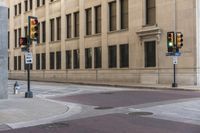 a corner with several stop lights at a city intersection and a red light at the intersection