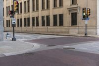 a corner with several stop lights at a city intersection and a red light at the intersection