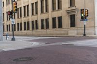 a corner with several stop lights at a city intersection and a red light at the intersection