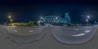 a 360 - view image of the train bridge and highway from outside a fisheye lens