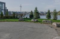 the large parking lot is surrounded by rocks and plants for storage and organization of equipment