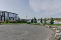 the large parking lot is surrounded by rocks and plants for storage and organization of equipment