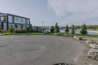 the large parking lot is surrounded by rocks and plants for storage and organization of equipment