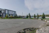 the large parking lot is surrounded by rocks and plants for storage and organization of equipment