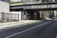 a person is riding a bike under an overpass in the middle of a city