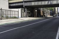 a person is riding a bike under an overpass in the middle of a city