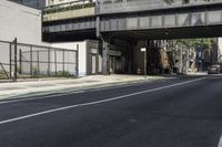 a person is riding a bike under an overpass in the middle of a city