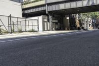 a person is riding a bike under an overpass in the middle of a city