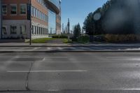 the shadow of a stop sign on a city street, next to a tree lined street