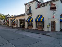 a very colorful looking building with lots of windows and awnings in it's corner