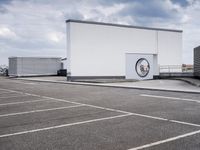 the large truck is parked in a parking lot with its door open and the sky above