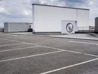 the large truck is parked in a parking lot with its door open and the sky above