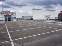 the large truck is parked in a parking lot with its door open and the sky above