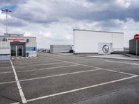 the large truck is parked in a parking lot with its door open and the sky above