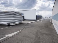 the large truck is parked in a parking lot with its door open and the sky above