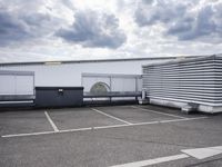 the large truck is parked in a parking lot with its door open and the sky above